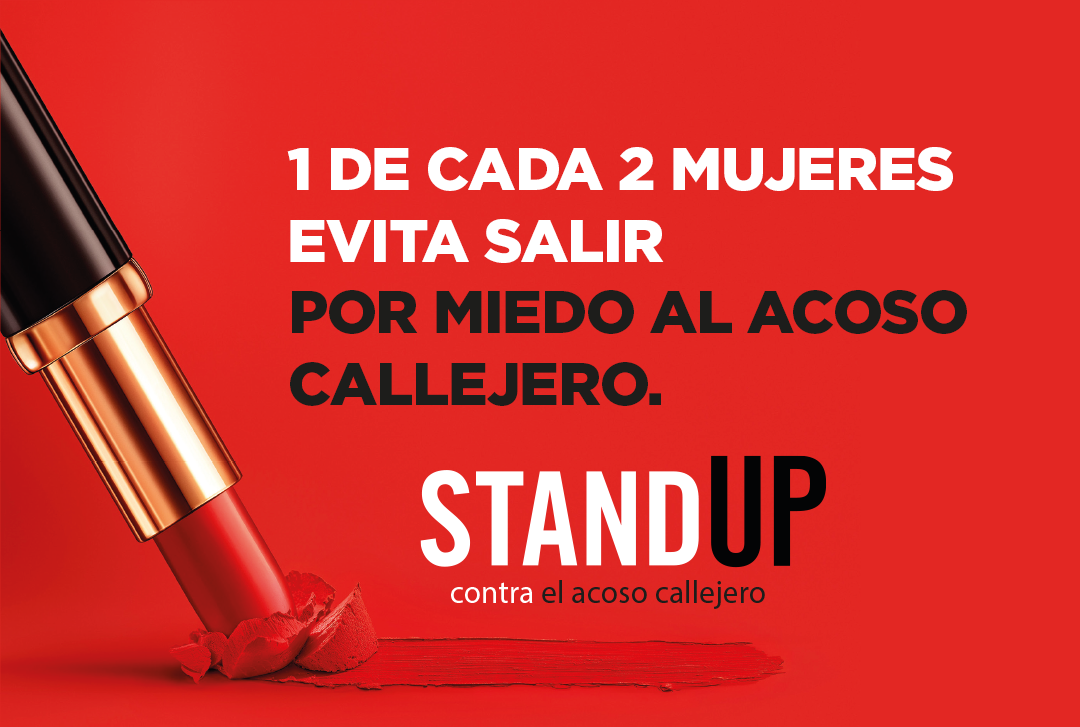 Red lipstick on a red background with text stating no es culpa de tu labial and el acoso callejero nunca es tu culpa advocating against street harassment.